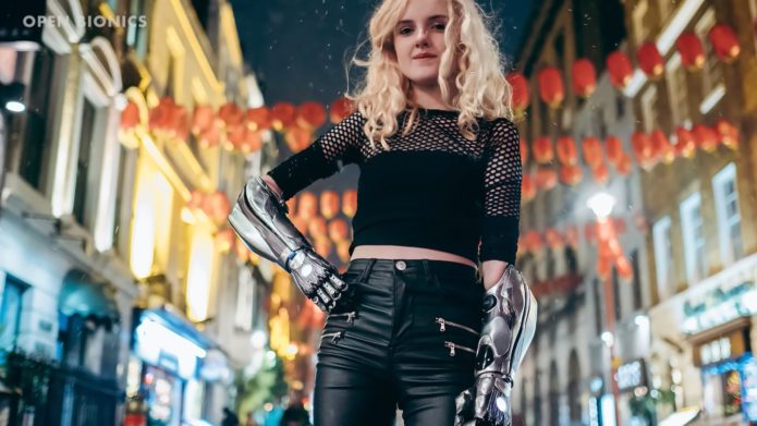 A teenage girl showing off her two bionic arms.